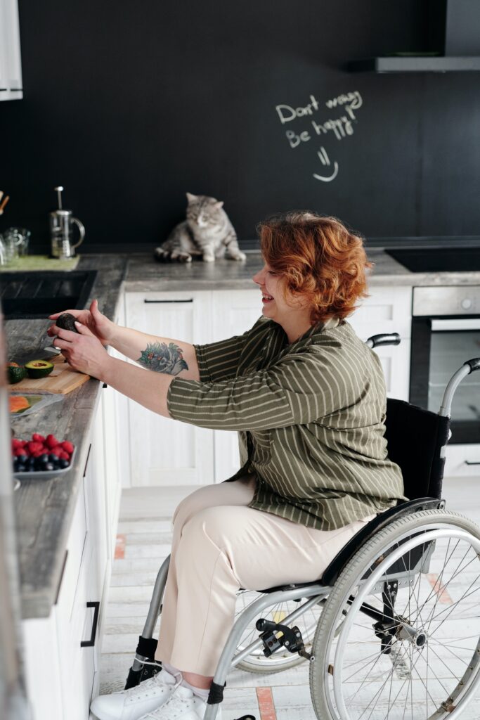 Photo: Woman using wheelchair in kitchen