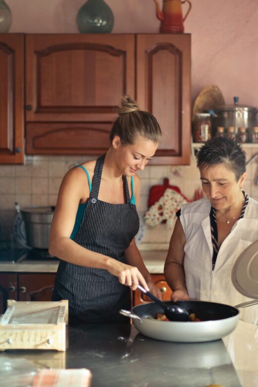 Photo: younger woman and older woman cooking in kitchen