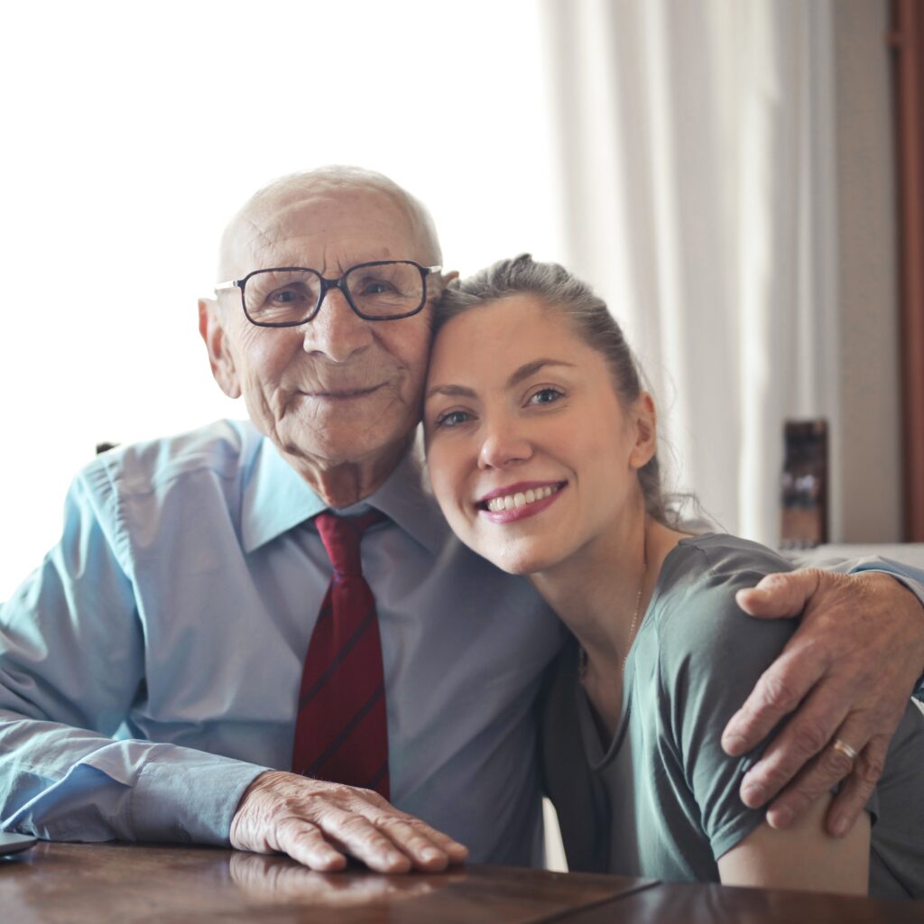 Photo: Older man and younger caregiver