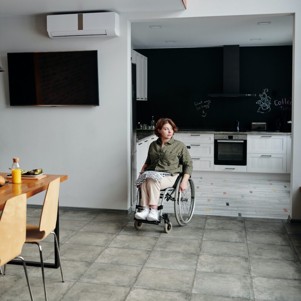 Photo: young woman in wheelchair between rooms